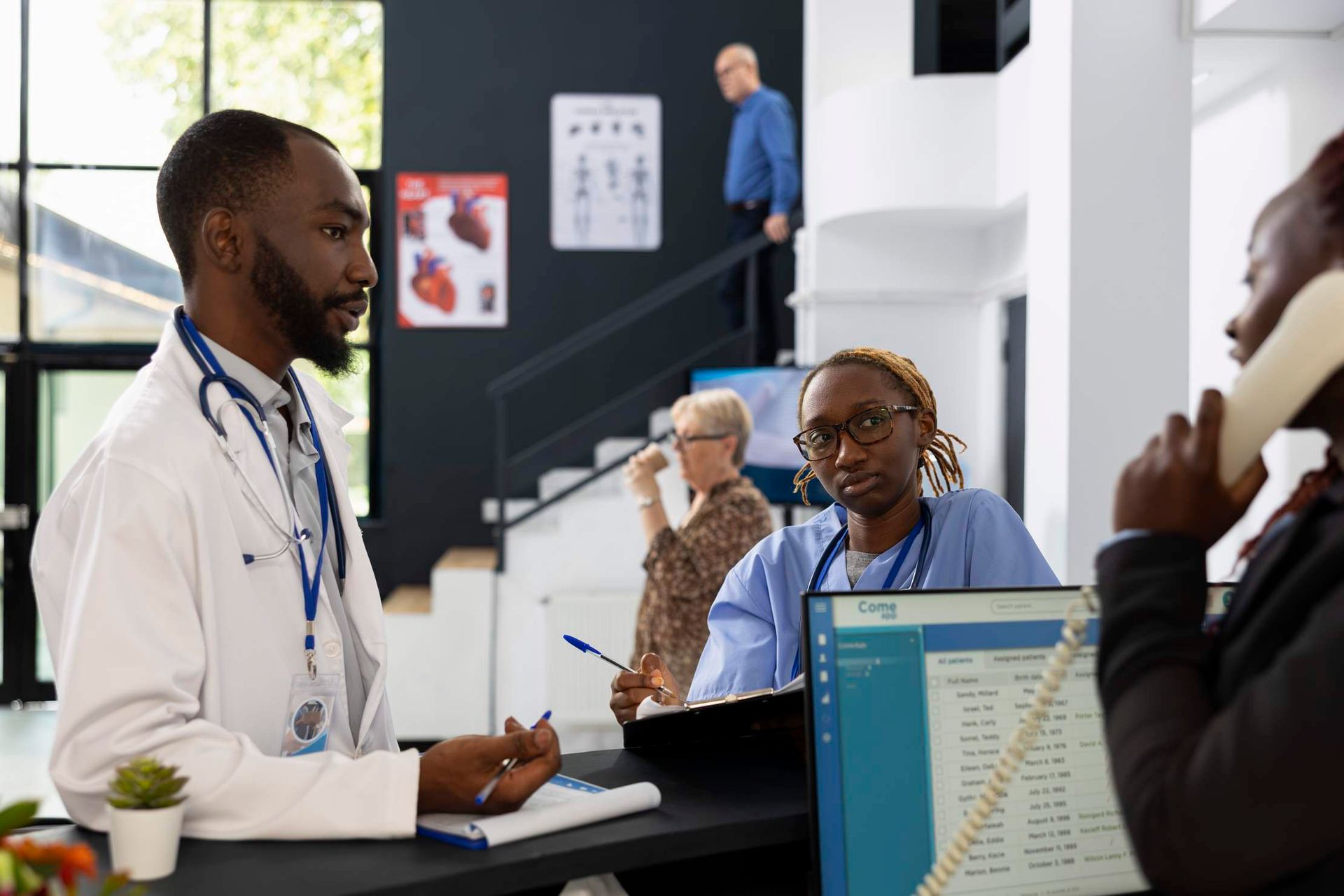 Staff interacting with a patient at a hospital reception desk