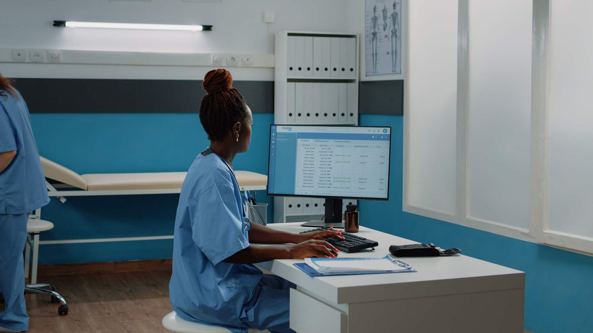 Nurse working at a clinic computer workstation