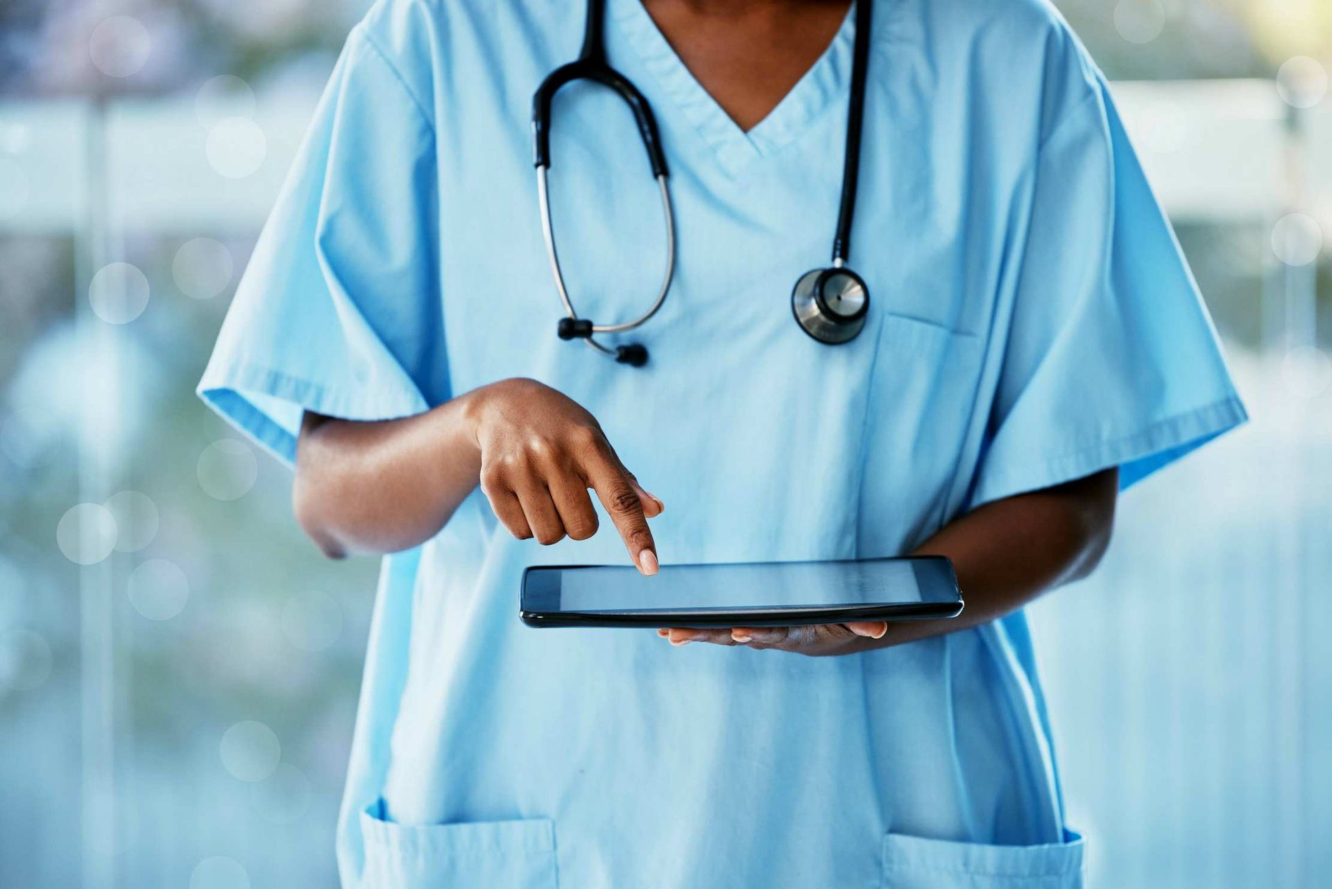 Close-up of a nurse holding a tablet device